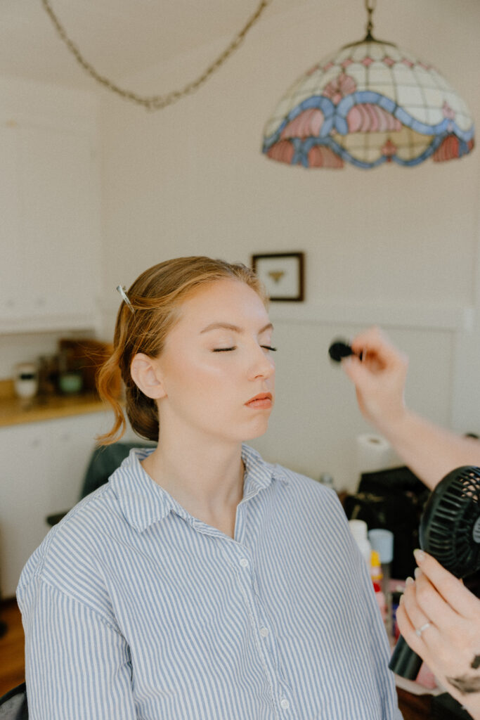 Bride getting her makeup done before her elopement in Santa Cruz CA.