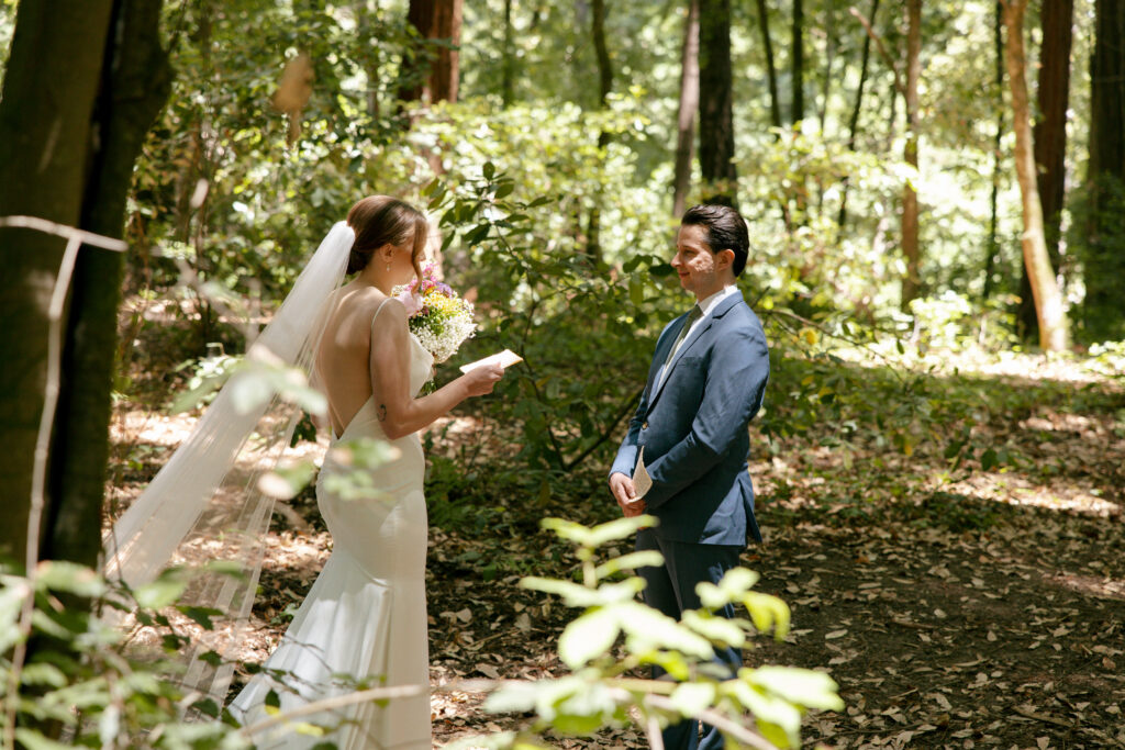 Bride and groom first look and exchanging of vows in the forest.